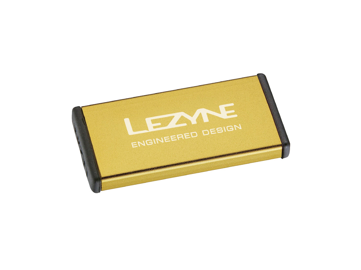 "Lezyne Metal Kit Puncture Patches in gold case with self-adhesive patches for durable and portable bike tire repair"







