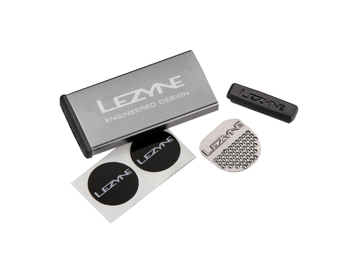 "Lezyne Metal Kit Puncture Patches in grey case with self-adhesive patches for reliable and compact bicycle tire repair"







